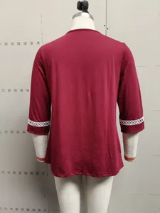 Back view of burgundy five-quarter sleeve casual top with delicate white lace cuffs