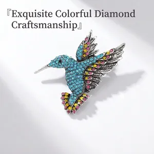 Macro view of colorful hummingbird brooch featuring blue and pink crystal rhinestones