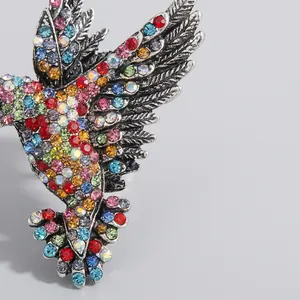 Vintage silver hummingbird brooch pin with vibrant multi-color rhinestones inlay details
