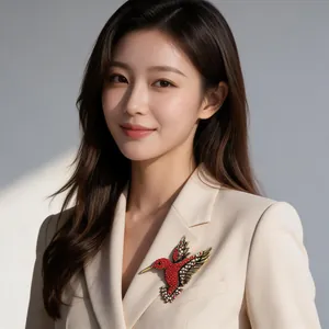 Elegant Asian model wearing a detailed hummingbird brooch with vibrant red rhinestones