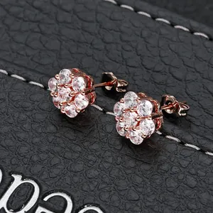 Detail shot of rose gold flower stud earrings with shimmering clear cubic zirconia