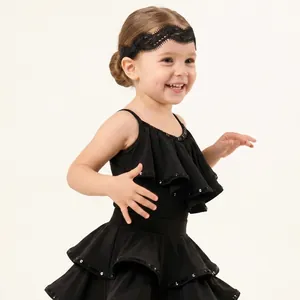 Detail view of a black lace headband worn by a child for Latin dance performances