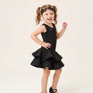 Detailed view of children's black lace floral headband worn during a dance performance