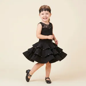 Close-up detail of a black hollow lace headband for kids Latin dance performance
