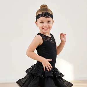 Detail view of a young girl wearing a black hollow lace headband for Latin dance.