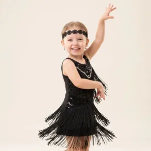 Little girl in black fringe Latin dance dress with matching lace headband posing