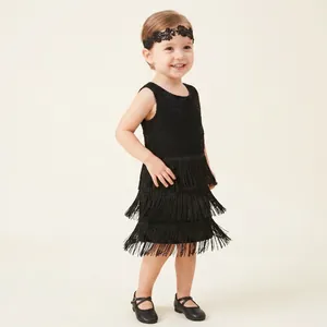 Detailed view of the black embroidered floral lace hairband on a young girl