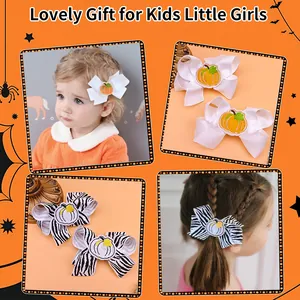 Macro detail view of cute embroidered pumpkin bow hair clips for kids and little girls