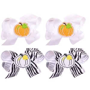 Set of 4 kids embroidered pumpkin bow hair clips featuring white and zebra ribbon patterns