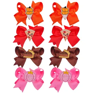 Set of embroidered bow hair clips with pumpkin and pizza designs for kids