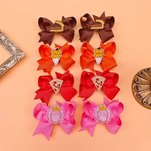 Detailed view of colorful Thanksgiving themed embroidered bow hair clips for girls