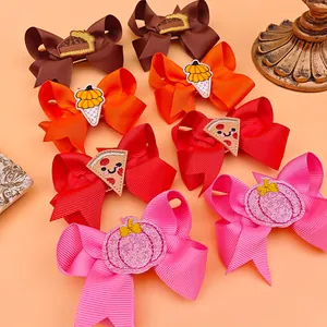 Detailed close-up of embroidery on colorful ribbon bow hair clips for kids Thanksgiving theme