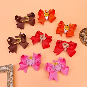 Detailed view of various colorful embroidered bow hair clips with Thanksgiving themes.