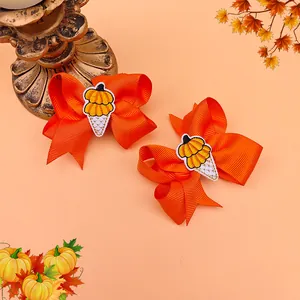Detail of orange grosgrain ribbon bows with embroidered pumpkin ice cream for kids