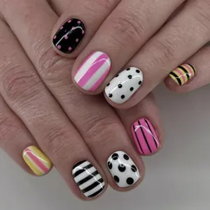 Detailed view of press-on nails featuring vibrant polka dots and stripes patterns.