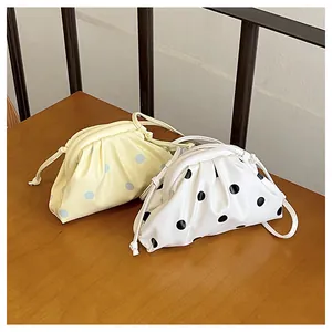 Detailed view of trendy ruched dumpling crossbody bags with stylish polka dot patterns