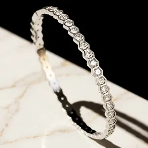 Close-up detail of a silver honeycomb design bangle set with sparkling hexagonal stones