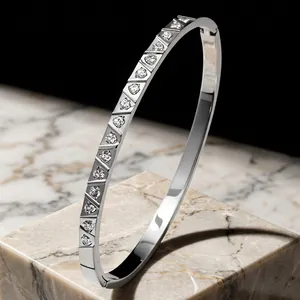Exquisite detail of silver titanium steel bangle with triangular crystal inlay design