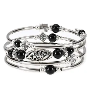 Close-up detail of bohemian multi-layer silver-tone wrap bracelet with black bead accents.
