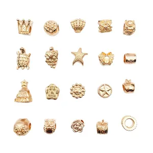 Assorted KC gold alloy charms for DIY bracelets and necklaces on a white background.