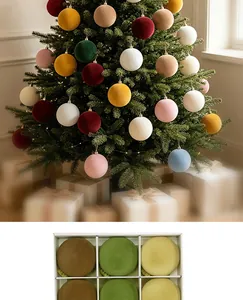 Close-up of elegant flocked Christmas balls on a tree and in a white gift box