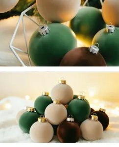 Close-up of matte flocked PET Christmas balls in green and beige on white fur.