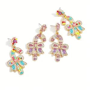 Festive Christmas candy cane drop earrings with colorful beads and rhinestone bows