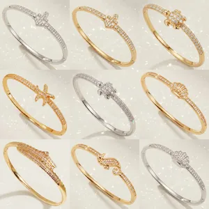 Collection of gold and silver zircon bangles featuring ocean-themed sea creature designs.
