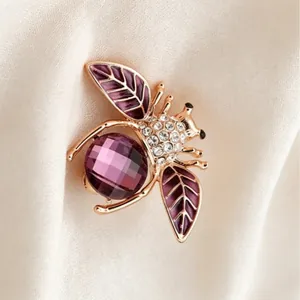 Elegant gold-tone bee brooch featuring purple crystals and sparkling rhinestones for women