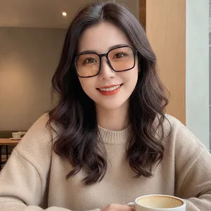 Fashionable tea-colored square sunglasses on female model in a cozy cafe setting