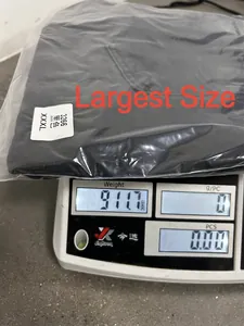 Weight measurement of black men's overalls denim pants in XXXL size on digital scale