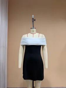 Close-up detail of black and white off-the-shoulder mini dress shown on a dress form