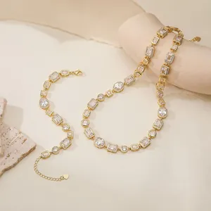 Detailed view of vintage gold geometric necklace and bracelet set with clear stones