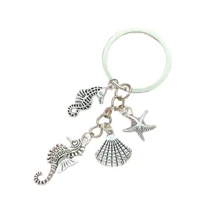 Ocean theme silver keychain featuring seahorse, starfish and seashell pendant charms