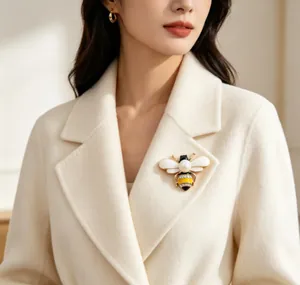 Detailed close-up of a charming honeybee brooch with white enamel wings on a coat lapel.