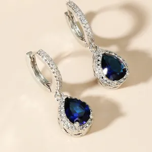 Elegant silver teardrop earrings featuring deep blue crystals and micro-pave setting