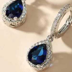 Elegant blue teardrop crystal dangle earrings with sparkling halo and silver finish