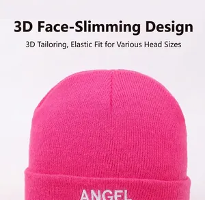 Close-up of a fuchsia knit beanie with white embroidered letter details for winter.