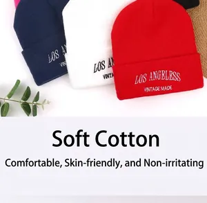 Detailed view showing the embroidery and soft texture of colorful knitted beanie hats.