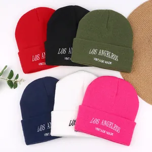 Assorted winter knit beanies with vintage embroidery for men and women outdoors