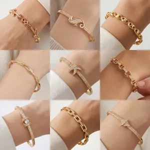Detail view of nine gold-plated copper bangles featuring zircon-inlaid patterns and motifs