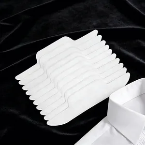 Disposable white collar sweat pads for shirts on black velvet background with shirt collar