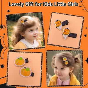Detailed view of festive embroidered pumpkin hair clips for kids on cute little girls