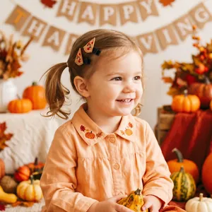 Close-up of child wearing Thanksgiving themed embroidered pumpkin hair clips