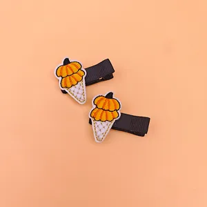 Close-up of safety embroidery hair clips with festive pumpkin ice cream theme for kids