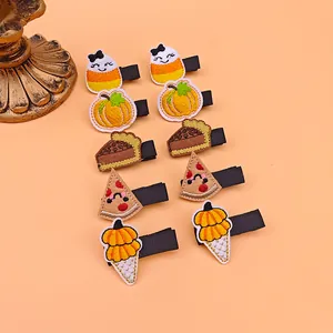 Set of ten embroidered Thanksgiving hair clips with pumpkin and pie designs for kids