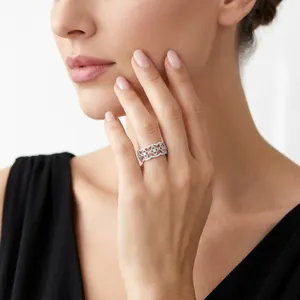 Elegant S925 sterling silver filigree ring with moissanite floral pattern worn by a model