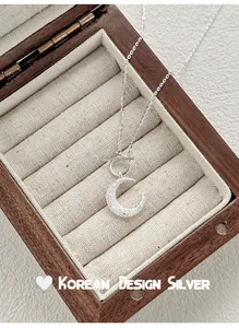 Detailed shot of s925 silver necklace with sandblasted moon pendant and OT buckle