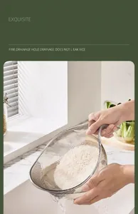 Close-up of a transparent kitchen rice sieve draining water while keeping grains inside.