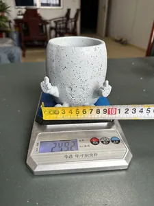 Detailed view showing the weight and dimensions of the resin middle finger flower pot